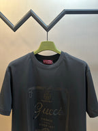 Dark navy T-shirt with round neck and metallic Gucci crest logo graphic