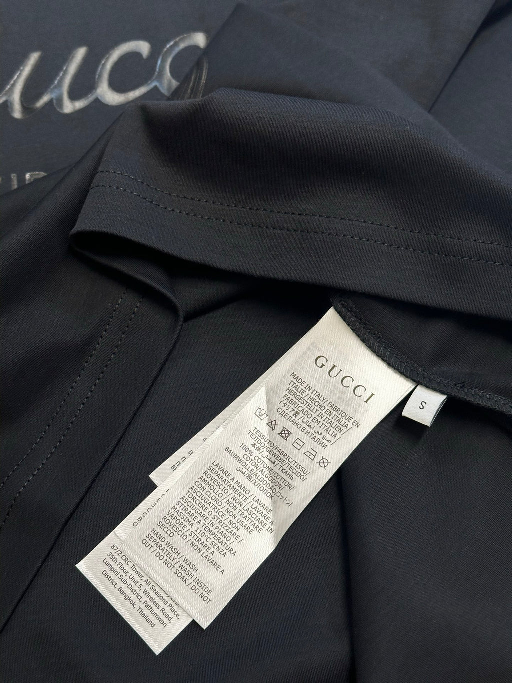 Dark navy T-shirt with inner neck label and size tag marked S