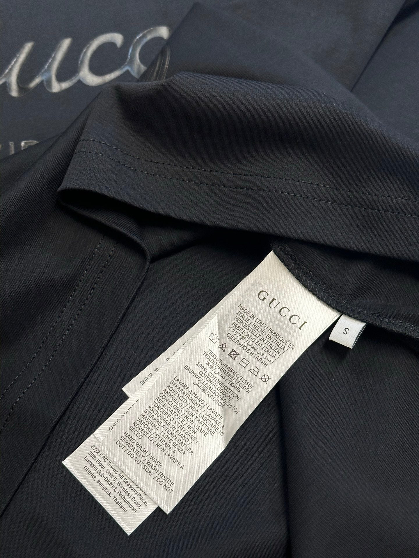 Dark navy T-shirt with inner neck label and size tag marked S