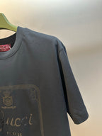 Dark navy T-shirt shoulder and sleeve with partial Gucci logo print