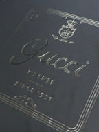 Dark navy T-shirt close-up of Gucci script with Firenze and Since 1921 text