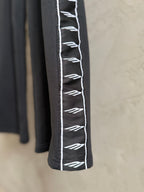 Black pants with white logo stripe detail on the side seam