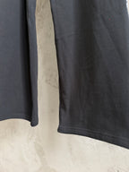 Black wide-leg pants with gathered hem and smooth fabric