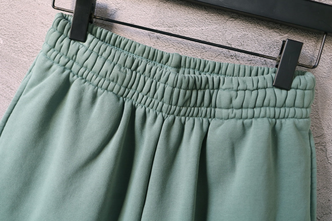 Teal shorts waistband with gathered elastic and belt-loop details