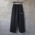 Black Balenciaga track pants with elastic waistband and wide straight legs