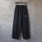 Black Balenciaga track pants with elastic waistband and wide straight legs