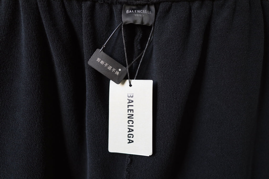 Black Balenciaga pants with hangtag and size label at waistband