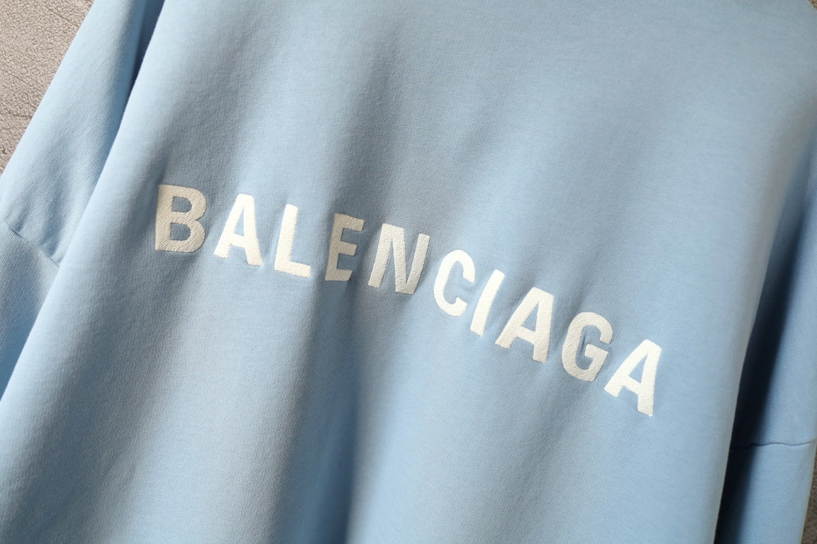 Balenciaga light blue hoodie close-up of BALENCIAGA logo