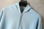 Light blue Balenciaga zip-up hoodie hood and metal zipper at the collar