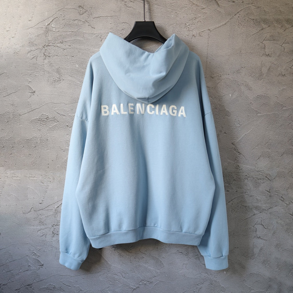 Light blue Balenciaga zip-up hoodie with large BALENCIAGA text on chest