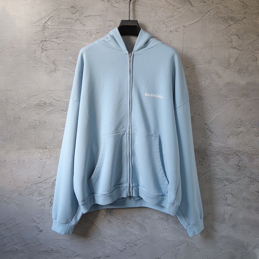 Light blue Balenciaga zip-up hoodie with drawstring hood and front zip