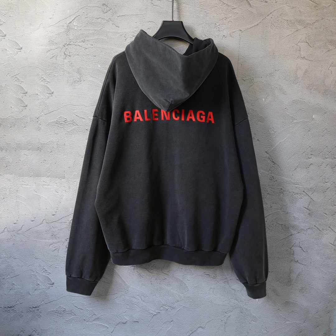 Black hooded sweatshirt with large red Balenciaga logo on back