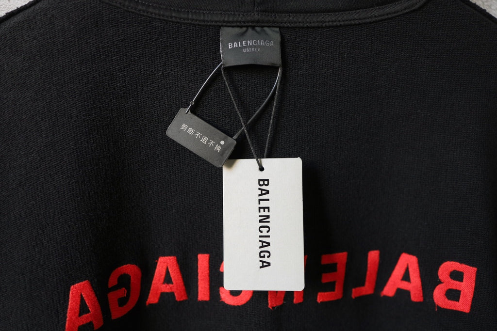 Black hoodie neckline with hanging tags and red Balenciaga logo print