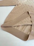 Folded light beige monogram sweater sleeve and ribbed hem