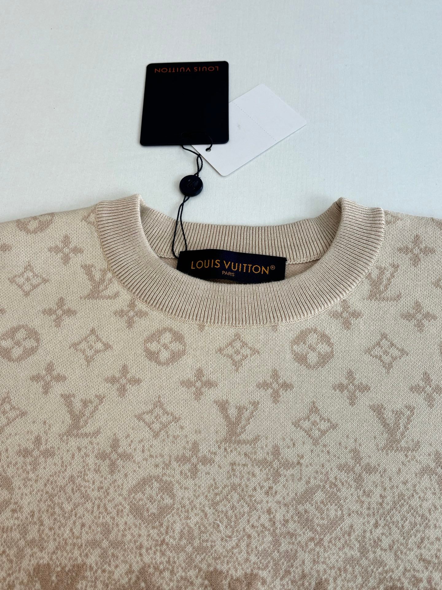 Light beige monogram sweater neckline with ribbed collar