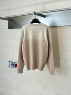 Light beige monogram long-sleeve sweater, back view on hanger