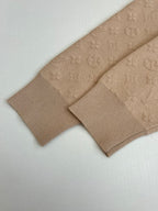 Light beige ribbed knit cuffs and monogram sleeve detail