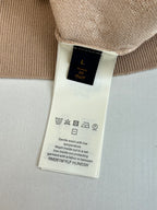 Light beige sweater care label on inside hem