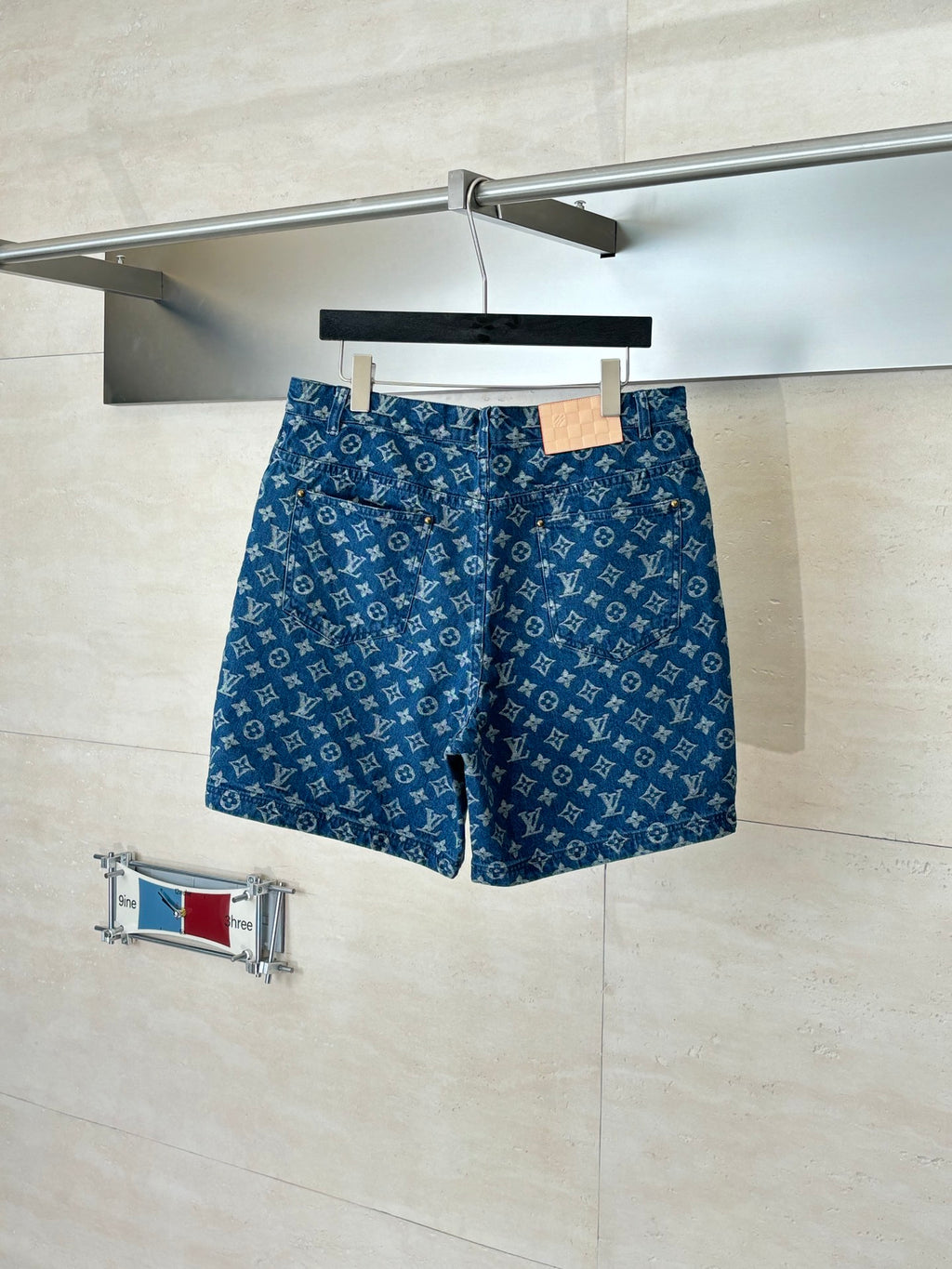 Louis Vuitton blue monogram denim shorts, with front pockets and button closure.
