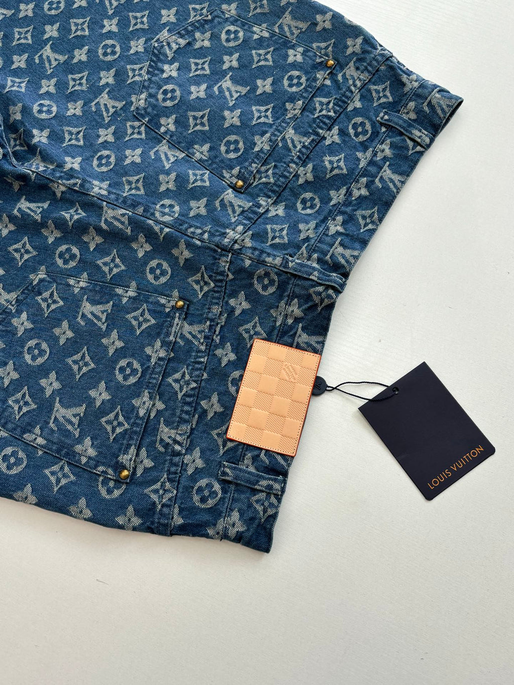 Louis Vuitton blue monogram denim shorts with hang tag, front pocket and button placket.