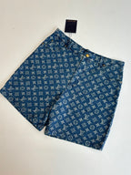 Louis Vuitton blue monogram denim shorts laid flat, front view with button placket.