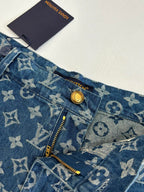 Louis Vuitton blue monogram denim shorts detail, gold button and zip at pocket opening.