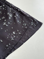Side view of dark navy printed shorts with small scattered white motifs