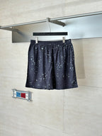 Dark navy printed shorts with elastic waistband and allover small light motifs