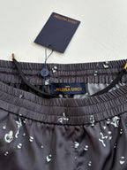 Waistband detail of dark navy printed shorts with elastic band and interior label