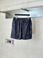 Dark navy printed shorts with elastic waistband and small white motif pattern