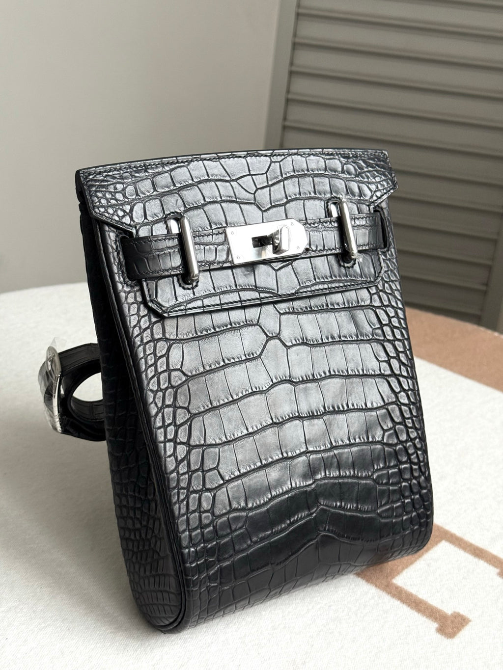 Hermes dark crocodile-embossed leather handbag, side view with strap