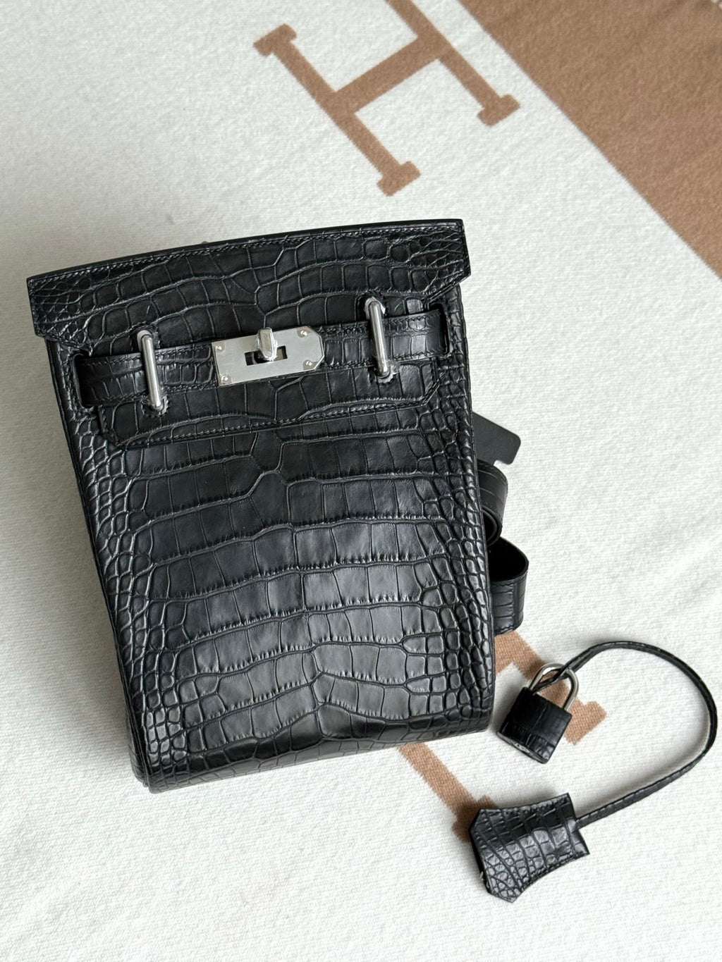 Hermes dark crocodile-embossed leather handbag with strap and clasp