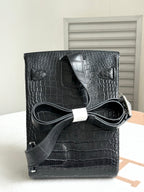 Hermes dark crocodile-embossed leather handbag with flap and shoulder strap