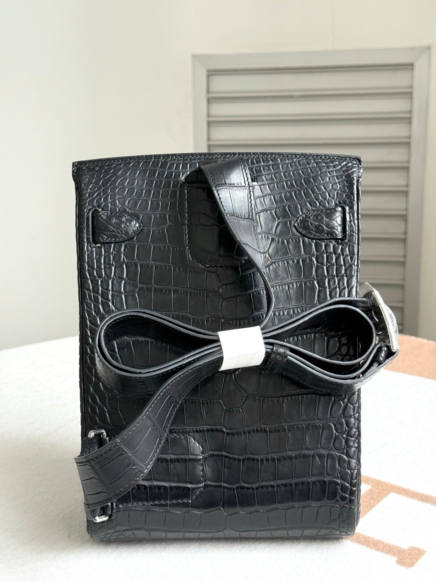 Hermes dark crocodile-embossed leather handbag with flap and shoulder strap
