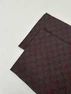 Gucci patterned pants, folded fabric showing dense allover pattern