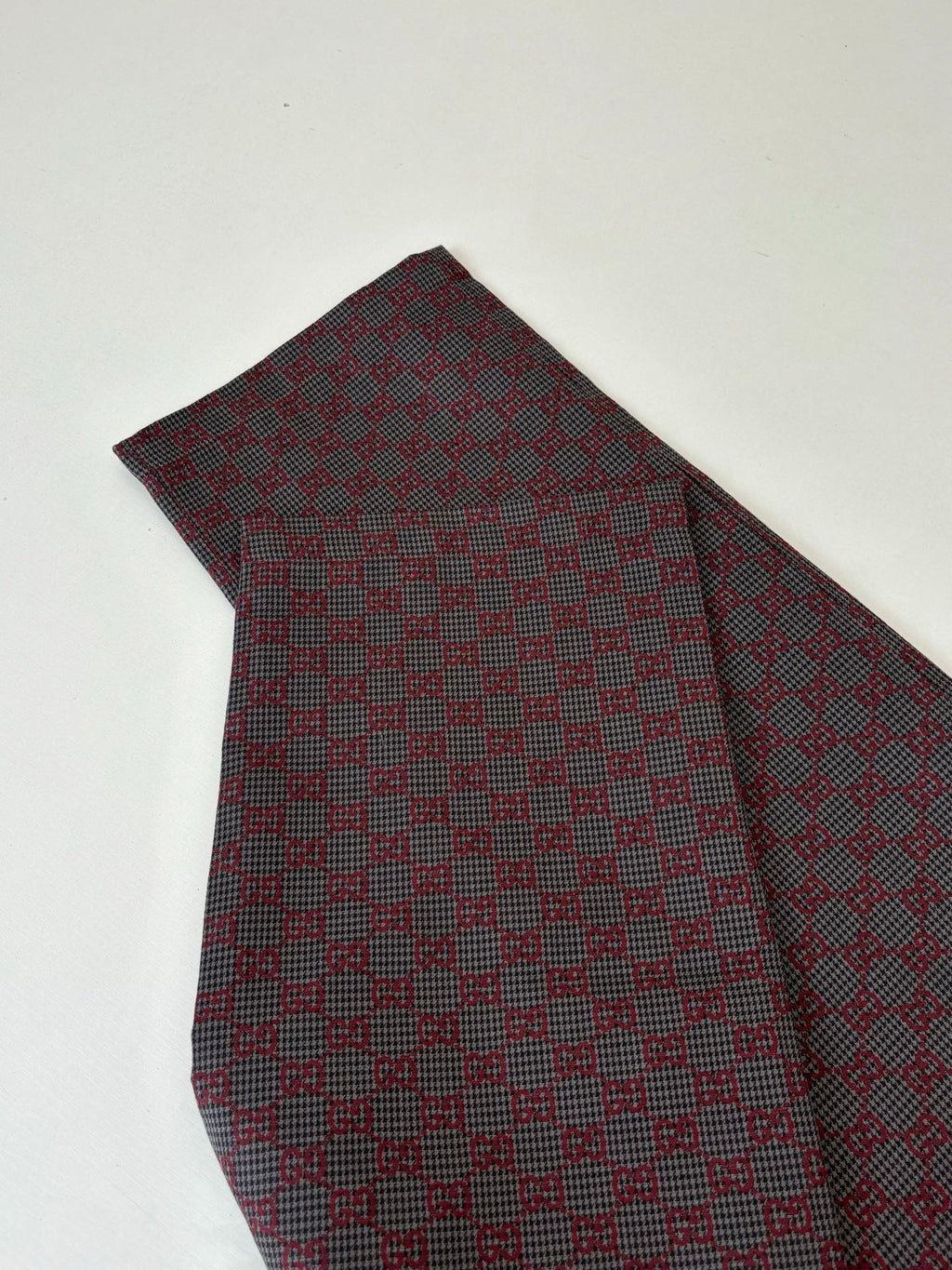 Gucci patterned pants with allover check-style fabric, folded