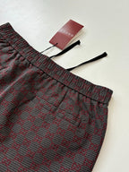 Gucci patterned pants with elastic waistband and drawstring ties, folded