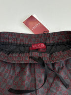 Gucci waistband with red label and black drawstring ties on patterned pants
