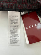 Long clothing care label with size tag and Gucci branded hang tag