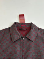 Gucci patterned jacket close-up, buttoned collar and zip placket in maroon and dark.