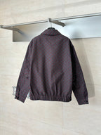Gucci jacket back on hanger, maroon and dark allover pattern, zip-front and elastic hem.