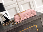 Light pink quilted bag with gold-tone chain strap and front flap with metal turn-lock
