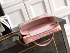 Light pink quilted shoulder bag with long zipper pocket and gold-tone chain strap