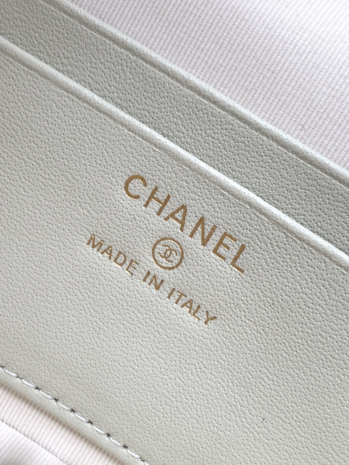 Chanel bag label in light cream with gold lettering and made in Italy