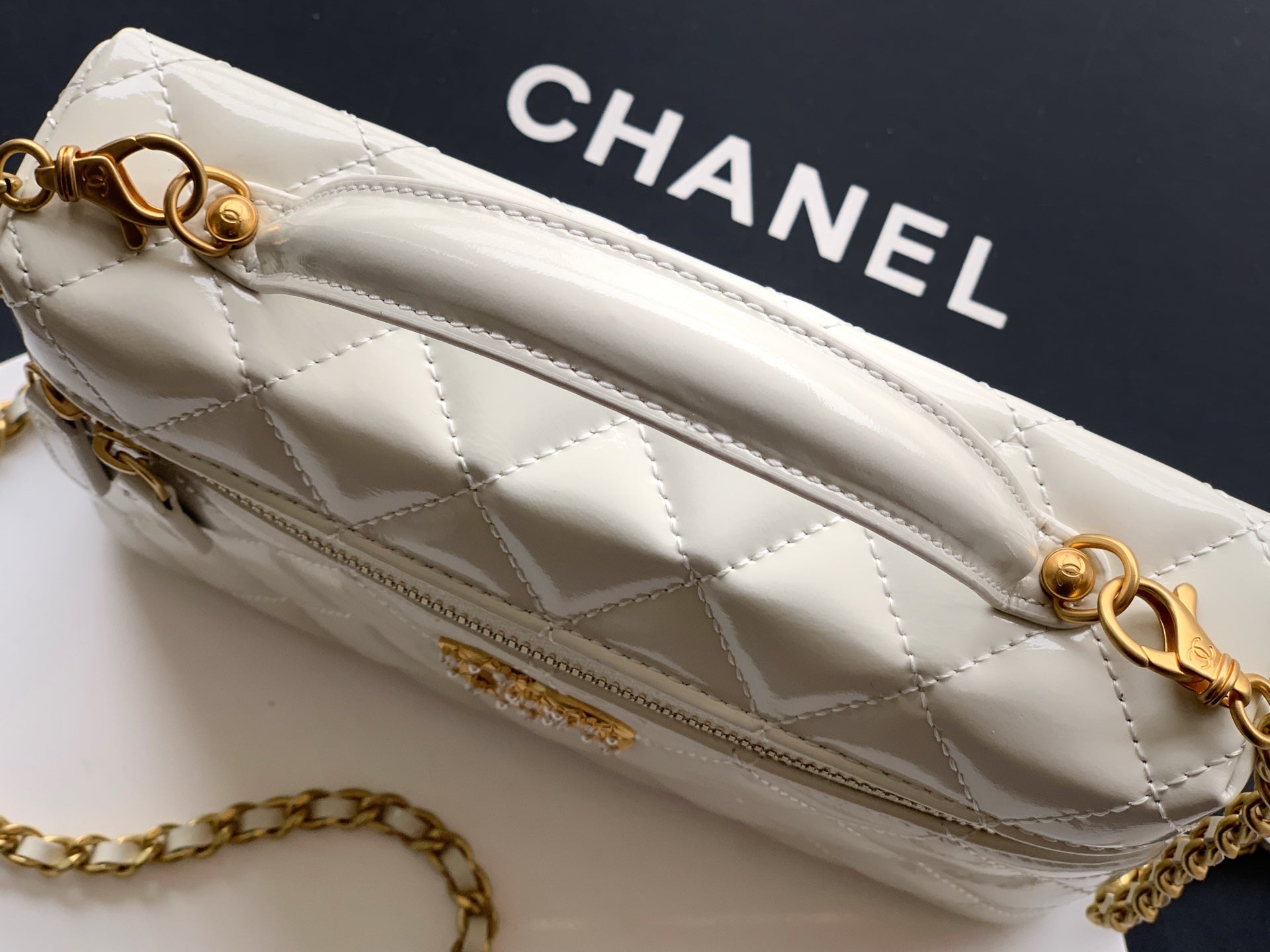 Chanel quilted mini bag in light cream with gold chain strap and CC emblem