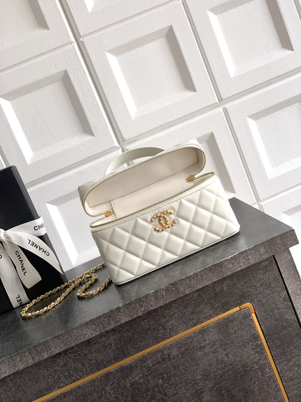 Chanel quilted handbag in light cream with top handles and gold chain strap