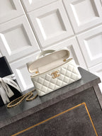 Chanel quilted handbag in light cream with top handles and gold chain strap