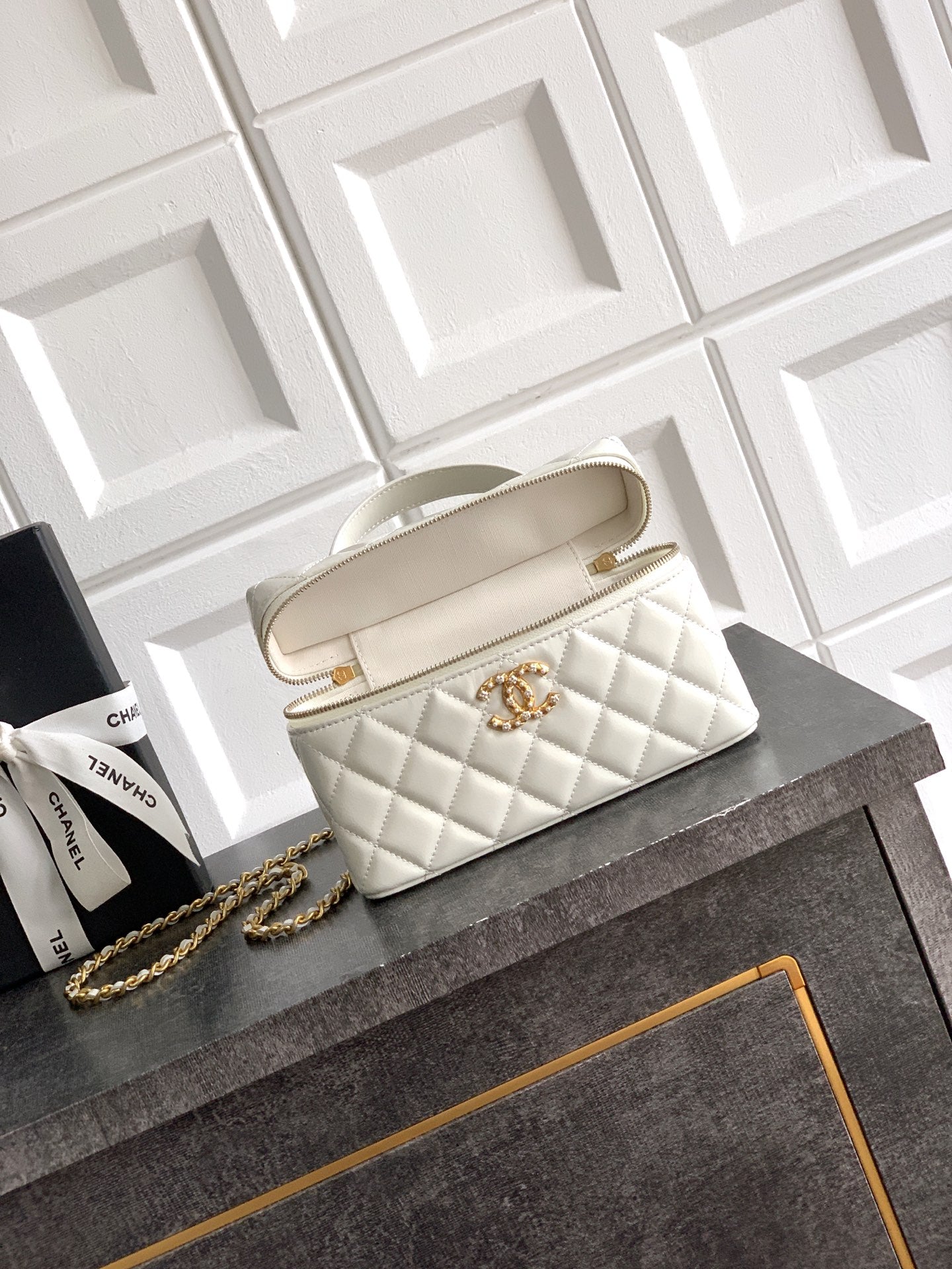 Chanel quilted handbag in light cream with top handles and gold chain strap