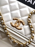Chanel quilted bag with gold CC emblem, front zip, and gold chain