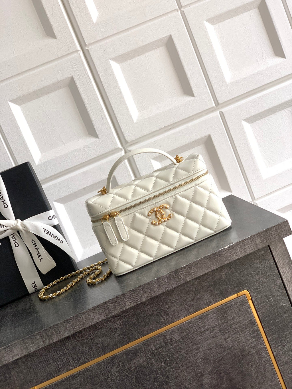 Chanel quilted handbag in light cream with top handles and gold chain strap